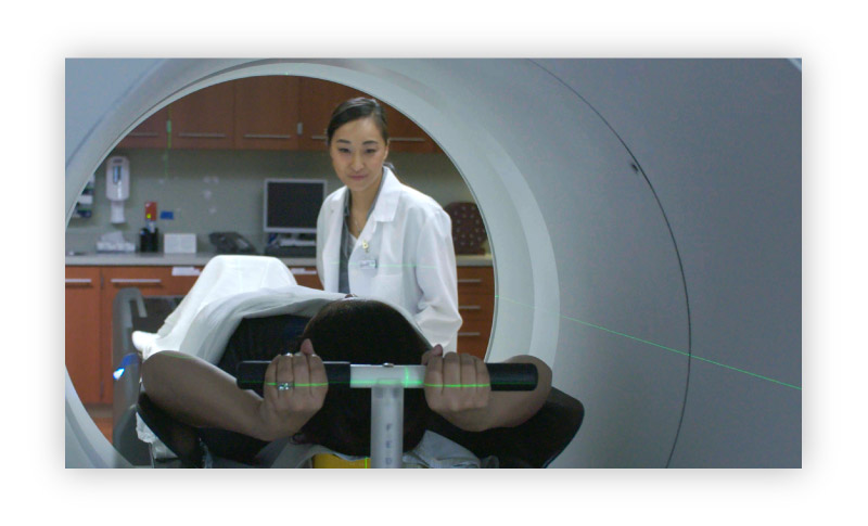 Clinician treating cancer patient with an Accuracy radiation oncology system